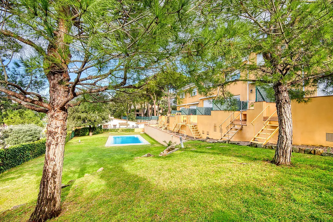 Corner townhouse with a communal pool.